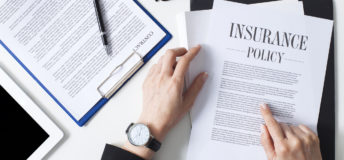 Business woman showing insurance document over white desk at office