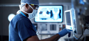 Shot of a surgeon looking at a monitor in an operating room