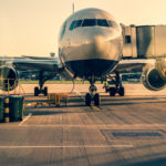 Front view of landed airplane in a terminal of Heathrow airport in London.